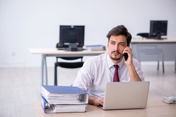 Young male employee working in the office