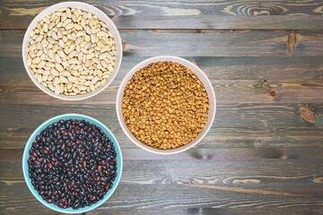 three ceramic bowls with various healthy grains. The concept of natural healthy food. Grains beans close up