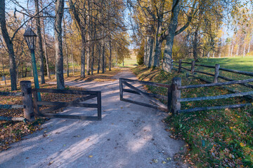 a narrow dirt path leading through an open wooden gate into a field. Mikhailovskoe. Pushkin...