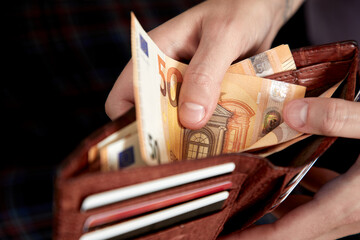 man handing wallet with euro