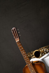Acoustic guitar and saxophone at floor. Music concept in studio with musical instrument