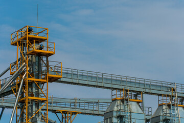 A large modern plant for the storage and processing of grain crops. view of the granary on a sunny day against the blue sky. End of harvest season.