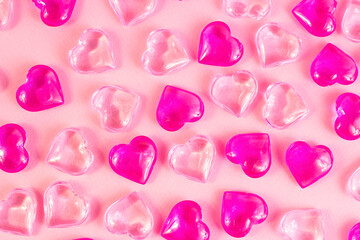 Many bright pink hearts on light rose color background. Valentines day decorative pattern.
