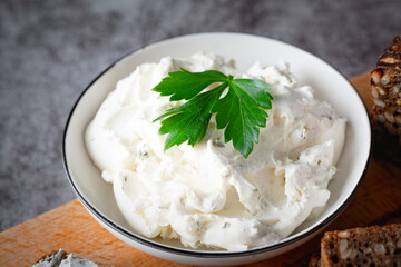 Bowl with fresh cottage cheese on table. Space for text