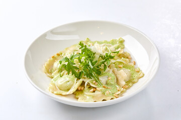 ravioli with pesto sauce on white plate