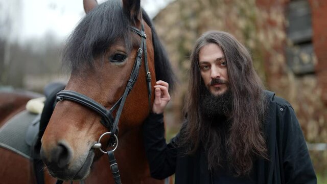 enigmatic warlock and his horse, dramatic historical shot, portrait of mysterious black magician