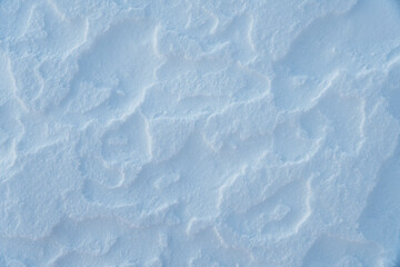 Snow background. Close up view of dry snow on the top of mountain.