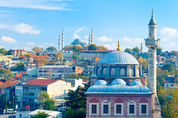 Naklejka premium In the heart of Istanbul: beautiful view of Sebsefa Hatun mosque and Ottoman imperial mosque - Suleymaniye in the background. Fatih, Istanbul, Turkey 