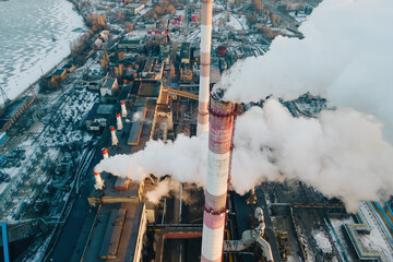 Factory smokestack emissions at sunrise, climate change and global warming for the environment. Aerial view