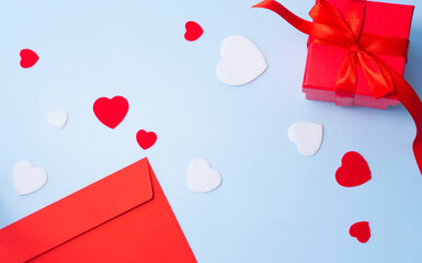 Red envelope, gift box and hearts on a blue background