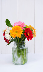 Transparent glass vase with a bouquet of gerberas