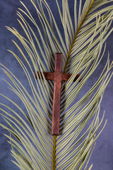 Catholic Cross with palm leaf. Ash Wednesday, Lent season, Holy Week, Good Friday and Palm Sunday concept. Copy space. - obrazy, fototapety, plakaty