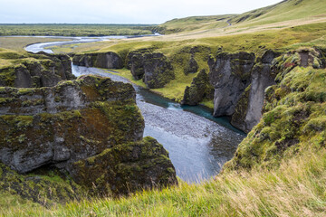 Fjaðrá river flowing through beautiful Fjadrargljufur canyon. Southern Iceland. Autumn overcast day.