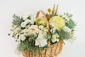 autumn bouquet with chrysanthemum and rose in a basket