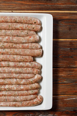 There are a lot of sausages in the white and clear plate. They look amazing.