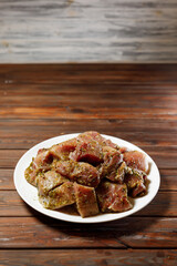 There are a plate with slices of fried meat on it.