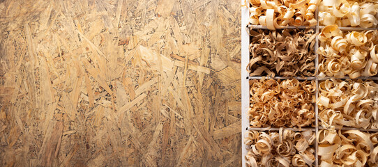 Wood shavings in box at table background. Wooden shaving from old plank board