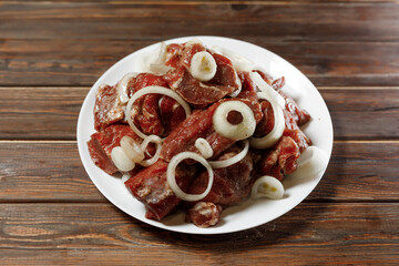 The plate of meat and onion is served to the customer.
