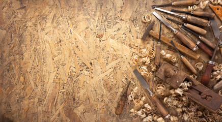 Plane jointer carpenter or joiner tool and wood shavings. Woodworking tools on wooden table