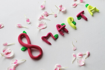 voluminous inscription for the women's Day holiday, top view, on a white background