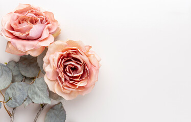 Flowers composition. Bouquet of pink roses in pastel colors. Flatlay.