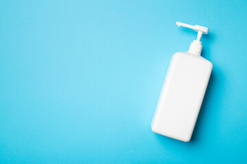 Hand sanitizer in white bottle on color background