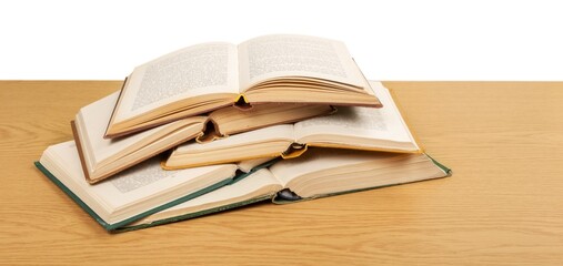 Stack open school books on desk