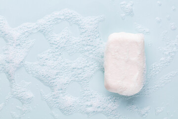Soap bar and foam on white background, top view. Mockup for design