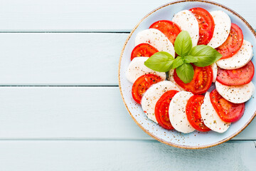 Classic caprese salad. Mozzarella tomatoes and  Basilikum.