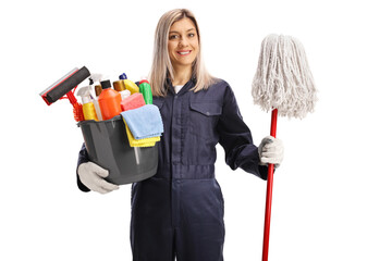 Female cleaner in a uniform holding a bucket of cleaning supplies and a mop