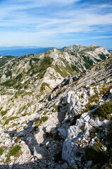 Rocky mountain peaks in the Julian Alps in Slovenia near the Vogel hill. Summer mountains and landscape over Lake Bohinj.