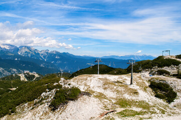 Rocky mountain peaks in the Julian Alps in Slovenia near the Vogel hill. Summer mountains and landscape over Lake Bohinj.