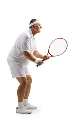 Full length profile shot of a mature man playing tennis