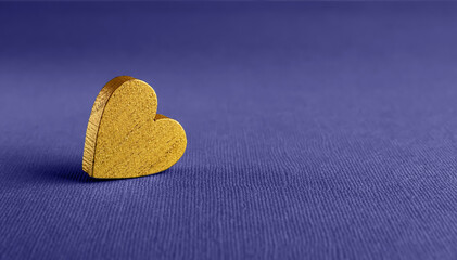 Golden valentine heart against textured blue violet background. Wide blank mockup for Valentine day holiday, greeting card and banner trendy in color of the year 2022 very peri. Macro. Copy space.