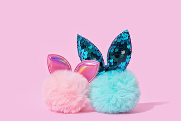 Easter blue and pink fur bunny on pink background. Minimal Easter concept
