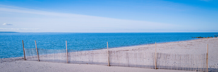 Fototapeta premium Beach seascape with sand fens at sunrise on Cape Cod. Empty beach in Vineyard Sound, Massachusetts.