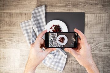 Man taking food photo using smartphone