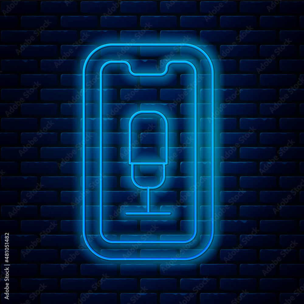 Poster glowing neon line mobile recording icon isolated on brick wall background. mobile phone with microph