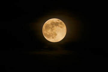 full moon in the night sky, orange moon glowing, isolated.