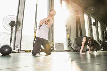 woman exercising with slamball during group training at gym in Bangkok
