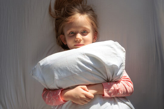 little girl woke up in the morning from sunlight
