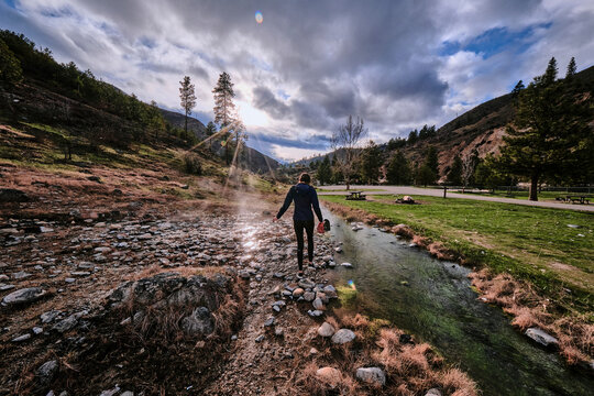A young woman following the water at Kirkham hot springs.