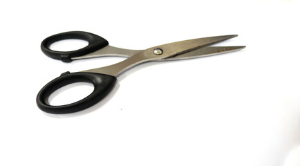 Photo Scissors of black paper, this tool is for cutting. This photo is with a white background
