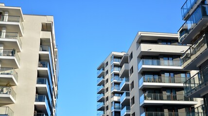 Fototapeta Facade apartment building with many windows balcony against blue sky obraz