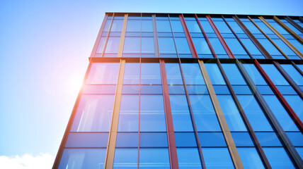 Abstract and complex blue skyscraper structure downtown  with sky and red sun in background