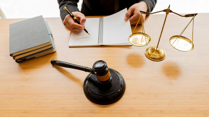 Lawyers work with hammers and scales in the office with tiger skins. justice concept judge Consultation and talks at the law firm concept of law The judge uses the scales of justice.