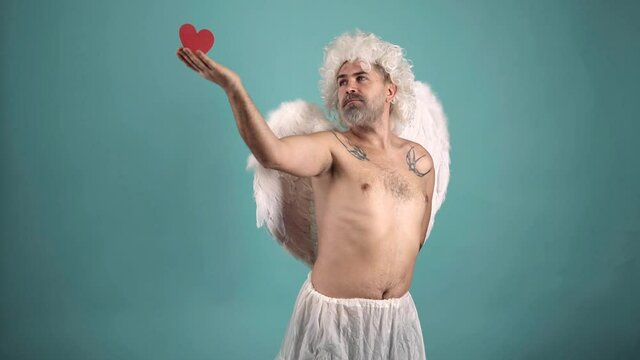 Valentines Day. Crazy gay angel man with heart. Valentin angel comic man with wings. Funny Valentines day celebration.