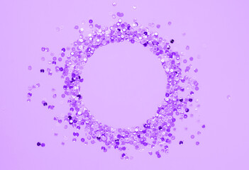 Sequins lilac confetti lined in round frame purple very peri background. Abstract festive composition place for text