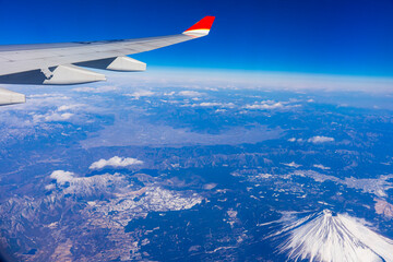 A view from the airplane window while flying over Mt. Fuji