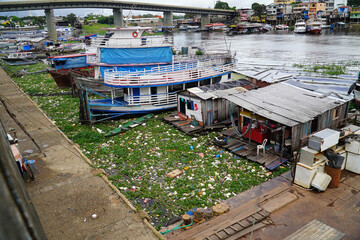 Plastic waste pollution. The Rio Negro river near the metropolis of Manaus. Garbage in the river...